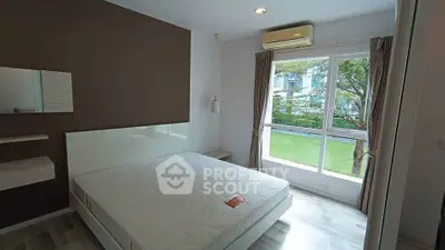 Modern bedroom with large window and garden view, featuring minimalist decor and air conditioning.