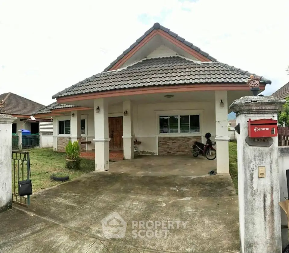 Charming single-story house with spacious driveway and traditional roof design