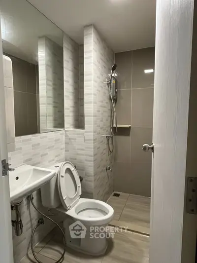 Modern bathroom with sleek shower and contemporary fixtures in a stylish apartment.