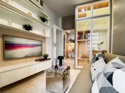 Modern living room with stylish decor and open shelving, featuring a cozy sofa and contemporary artwork.