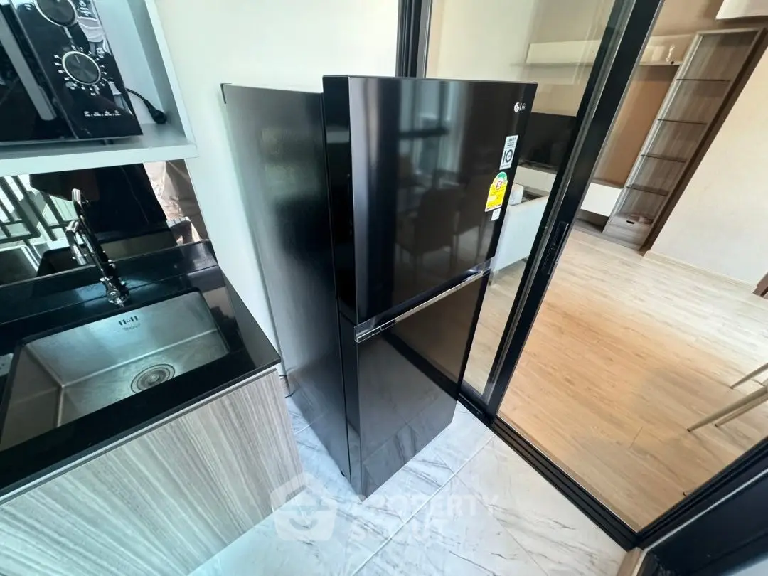 Modern kitchen with sleek black fridge and stylish cabinetry