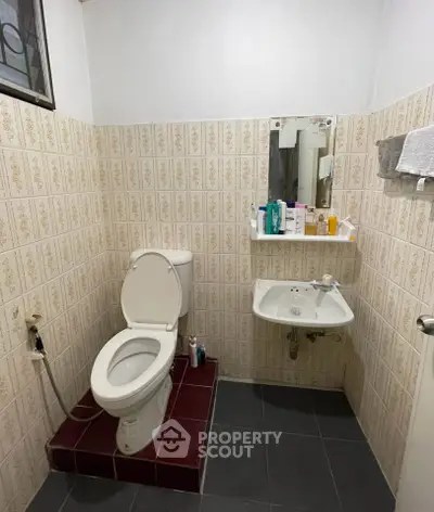 Cozy bathroom with vintage tiles and modern fixtures, perfect for compact spaces.