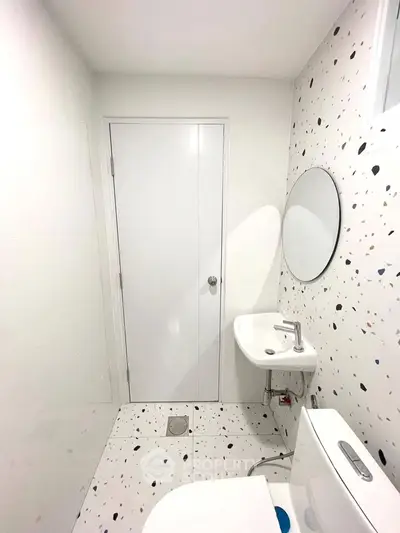 Modern minimalist bathroom with terrazzo tiles and round mirror