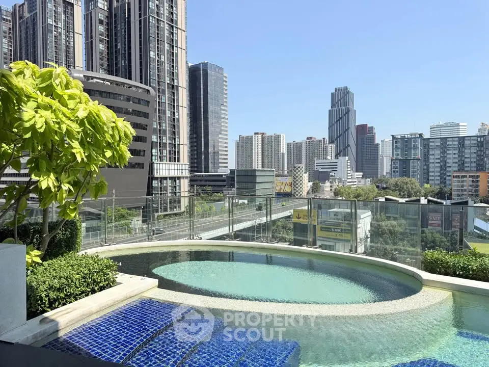 Luxurious rooftop pool with stunning city skyline views in modern urban setting.
