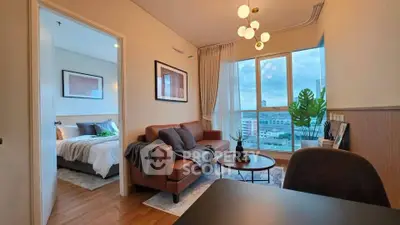 Modern living room with cozy seating and bedroom view, featuring large windows and stylish decor.