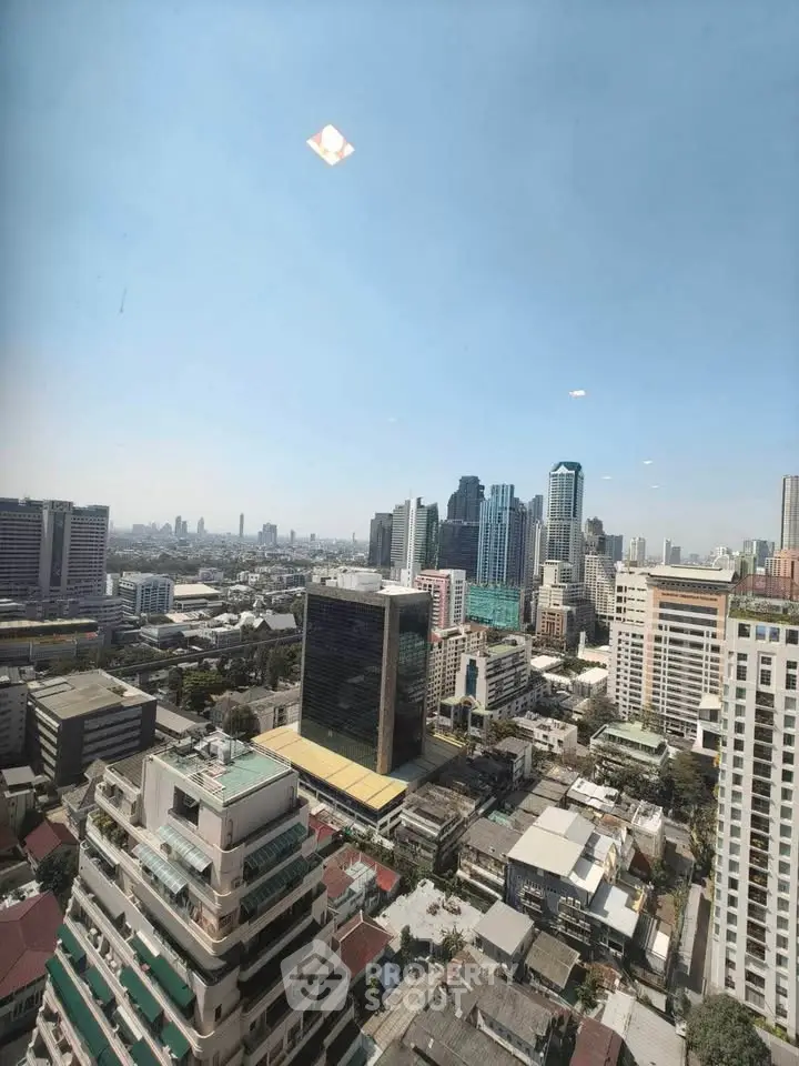 Stunning cityscape view from high-rise building showcasing urban skyline and architectural diversity.