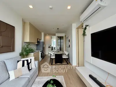 Modern living room with open kitchen, stylish decor, and natural light