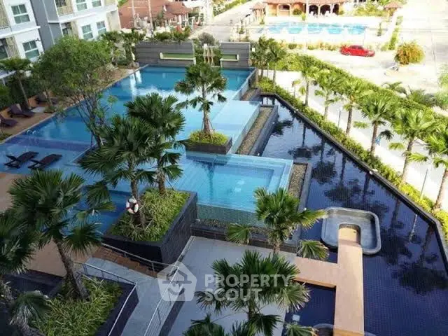 Luxurious apartment complex with stunning multi-level swimming pool and lush landscaping.