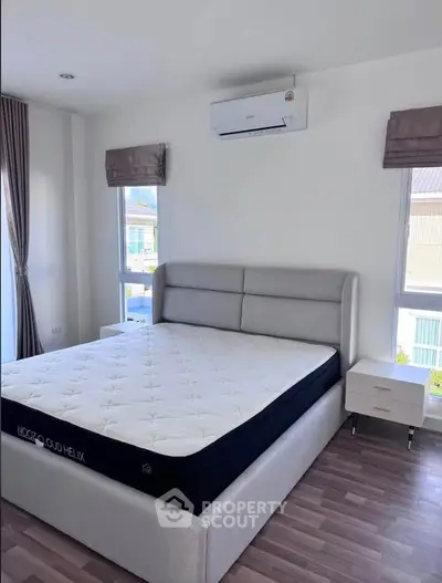 Modern bedroom with stylish bed and natural light in a contemporary apartment.