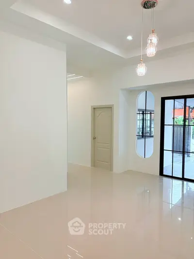 Spacious modern living room with elegant lighting and large windows for natural light.