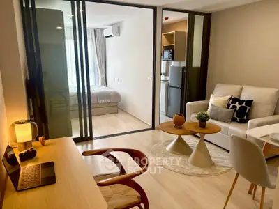 Modern open-plan living room with cozy bedroom and stylish decor