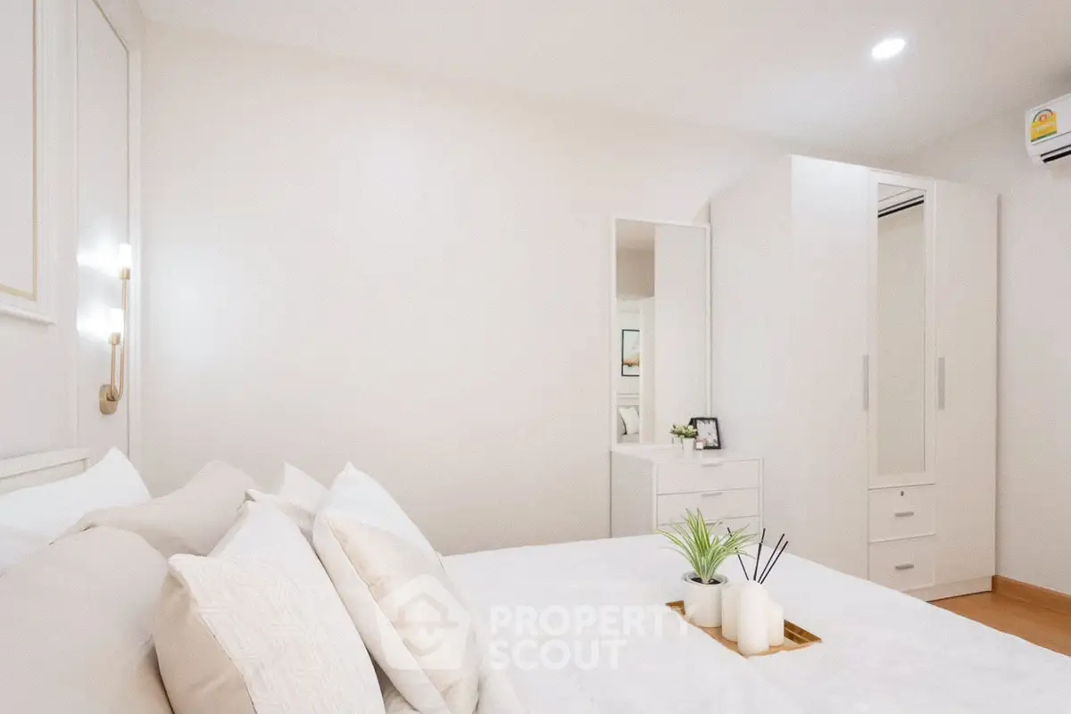 Elegant bedroom with modern decor and ample storage space