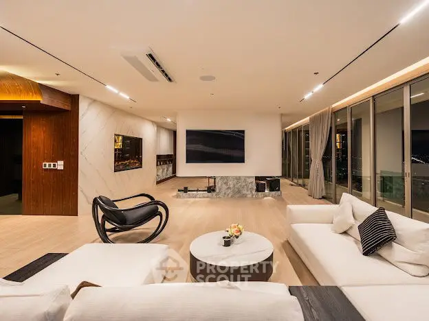 Luxurious modern living room with panoramic city views and stylish furnishings.