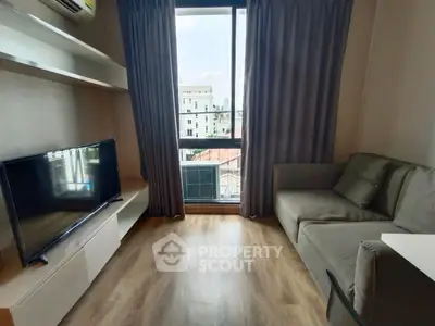 Modern living room with large window and sleek furniture