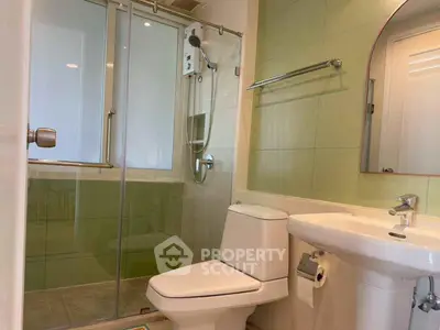 Modern bathroom with glass shower enclosure and sleek fixtures