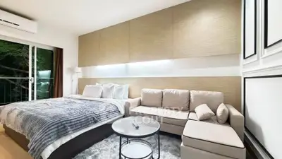 Luxurious bedroom with modern decor and cozy seating area, featuring a large bed and stylish furnishings.