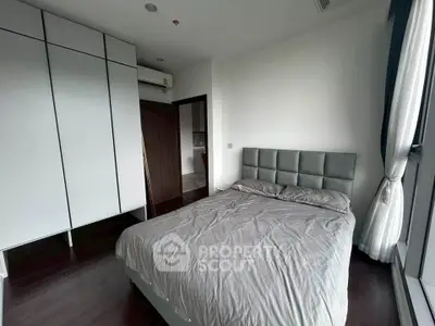 Modern bedroom with sleek design and large window for natural light