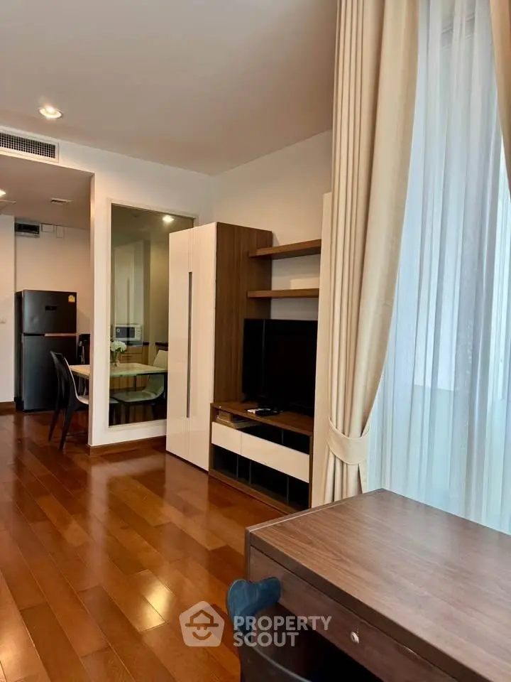 Modern living room with wooden flooring and stylish furniture in a cozy apartment.