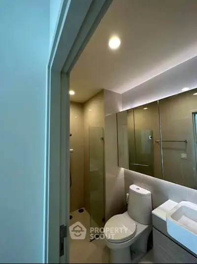 Modern bathroom with sleek fixtures and glass shower enclosure