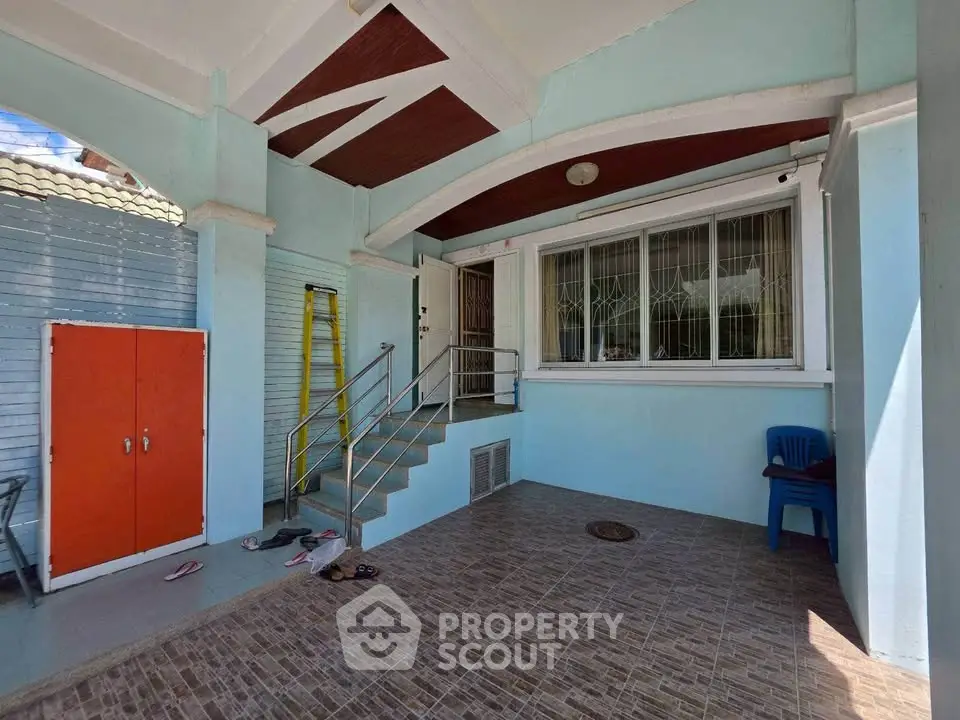 Charming home entrance with tiled patio and modern design