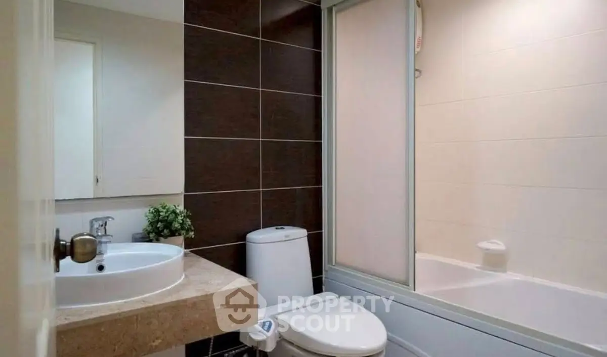 Modern bathroom with sleek design and bathtub in contemporary apartment.