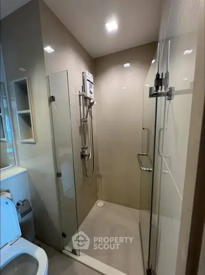 Modern bathroom with glass shower enclosure and sleek fixtures