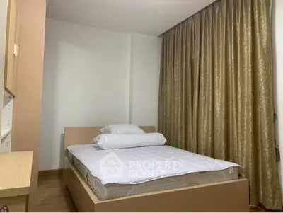 Cozy bedroom with modern furnishings and elegant curtains, perfect for restful nights.