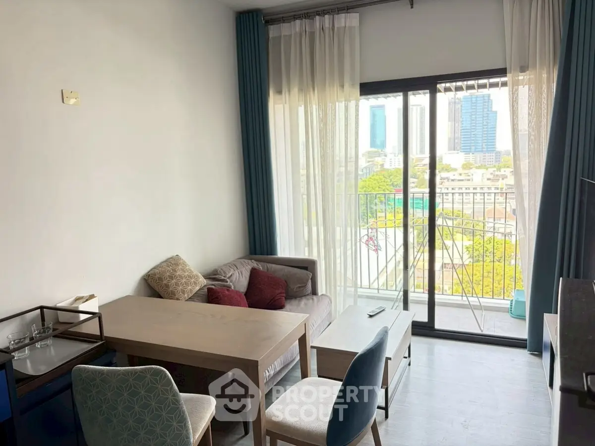 Bright living room with city view and balcony access in modern apartment.
