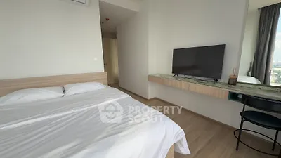 Modern bedroom with sleek design, featuring a wall-mounted TV and large window with city view.