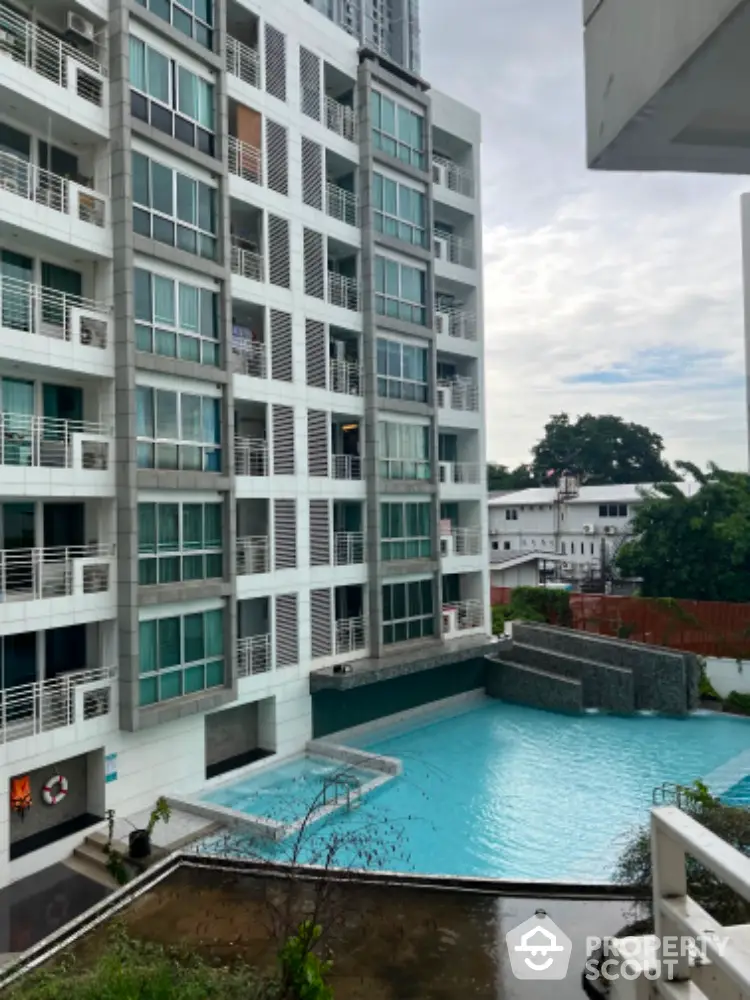 Modern apartment building with pool view, ideal for urban living