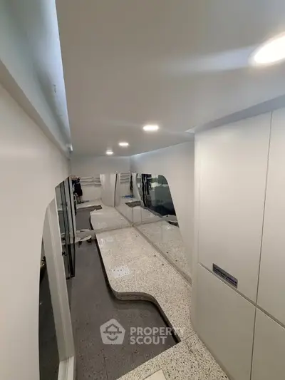 Modern interior hallway with sleek design and recessed lighting