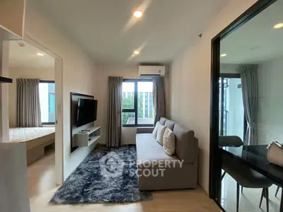 Modern living room with cozy sofa and wall-mounted TV in stylish apartment