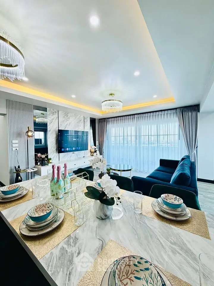 Luxurious modern living room with elegant dining setup and plush seating, perfect for entertaining.