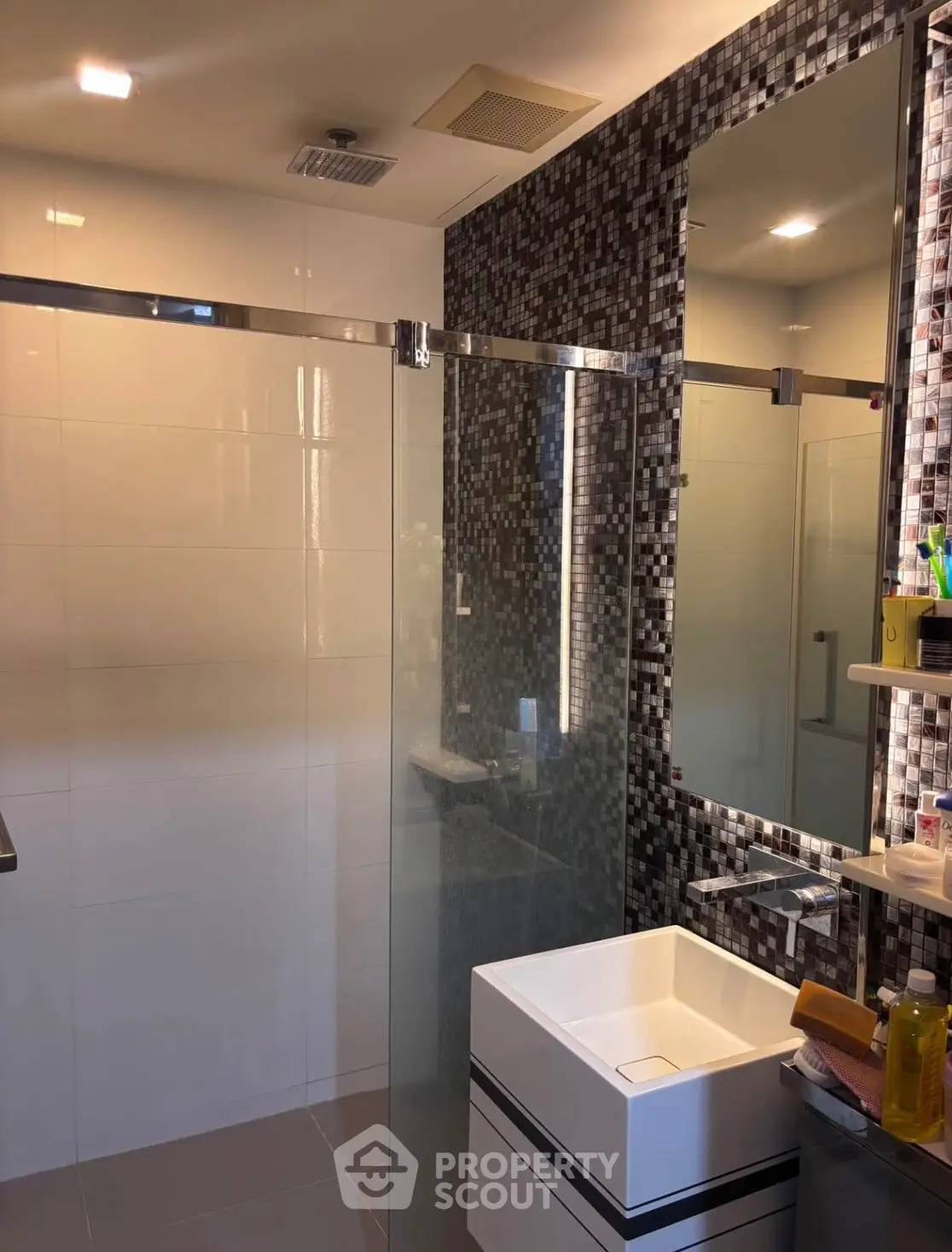 Modern bathroom with sleek shower and stylish mosaic tiles