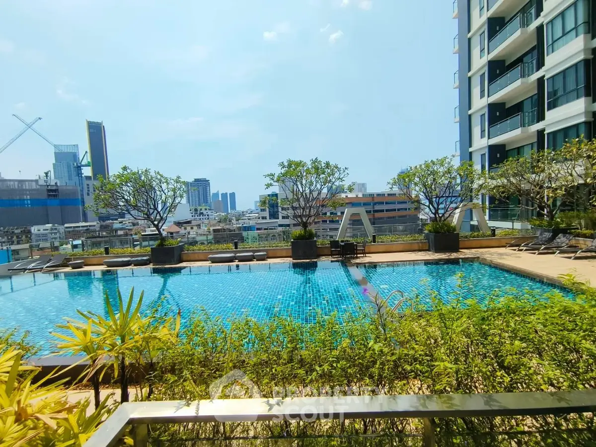 Luxurious high-rise apartment with stunning pool and city view, perfect for urban living.