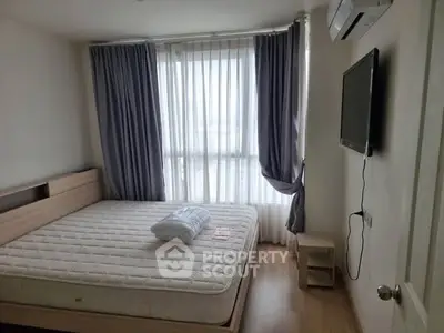 Cozy bedroom with large window and modern amenities