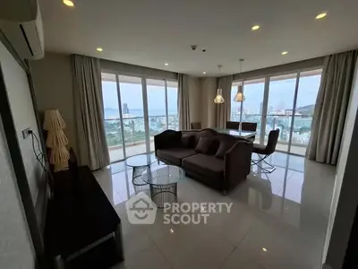 Spacious living room with panoramic city views and modern furnishings