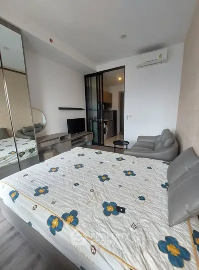 Modern bedroom with mirrored closet and cozy seating area