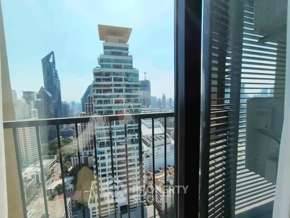 Stunning cityscape view from high-rise balcony with modern architecture.