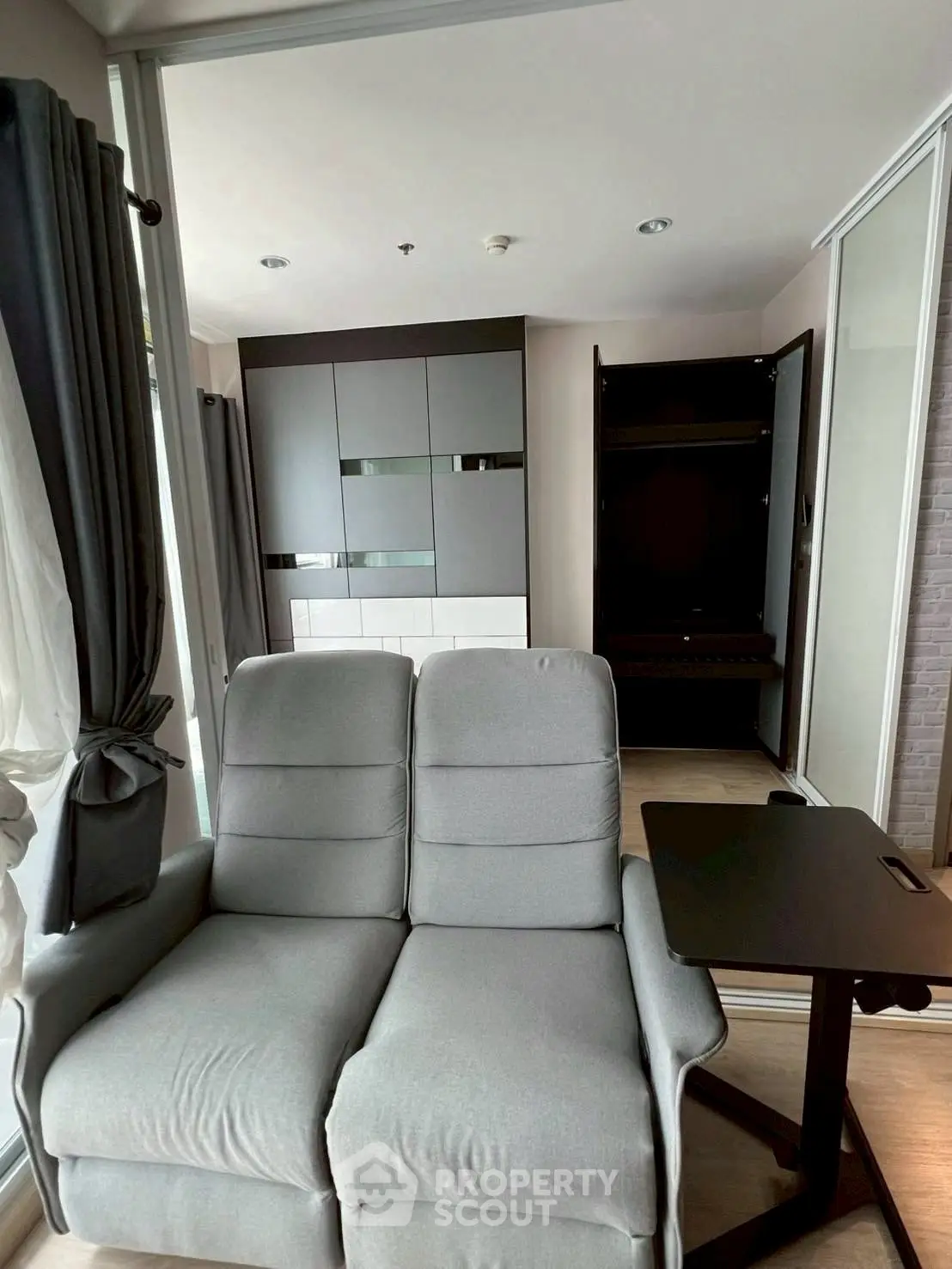 Modern living room with sleek gray sofa and stylish storage unit