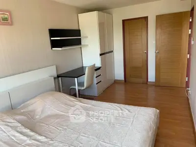 Spacious bedroom with modern furniture and wooden flooring