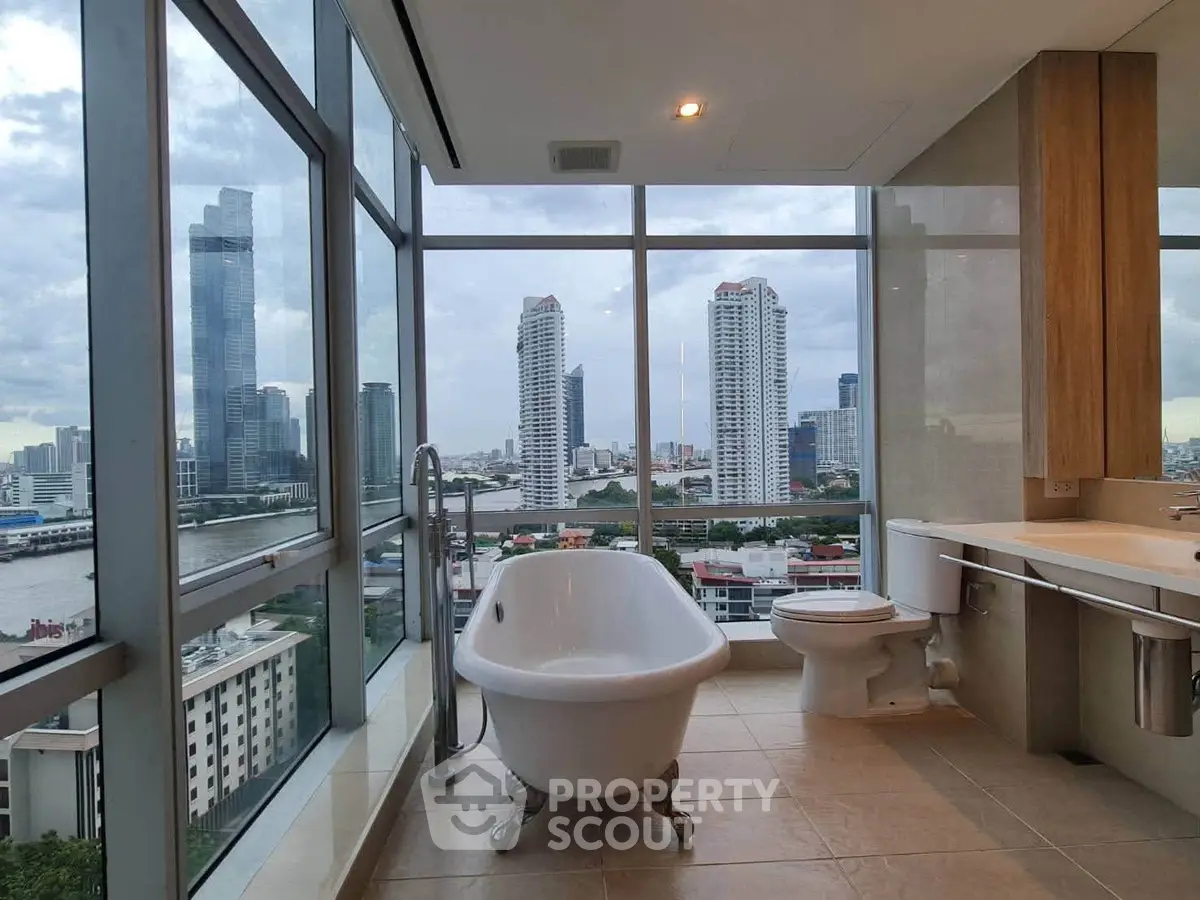 Luxurious bathroom with stunning city skyline view and elegant freestanding bathtub.