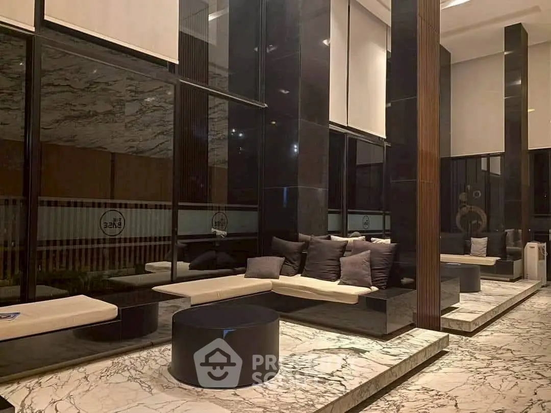Luxurious modern lobby with marble flooring and elegant seating area.