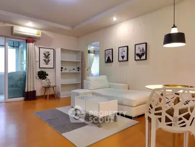 Modern living room with stylish decor, white sofa, and elegant lighting in a cozy apartment.