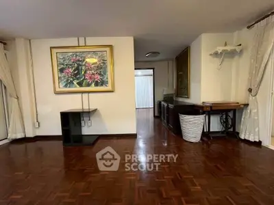 Spacious living room with elegant wooden flooring and stylish decor