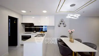 Modern kitchen with sleek dining area and elegant lighting
