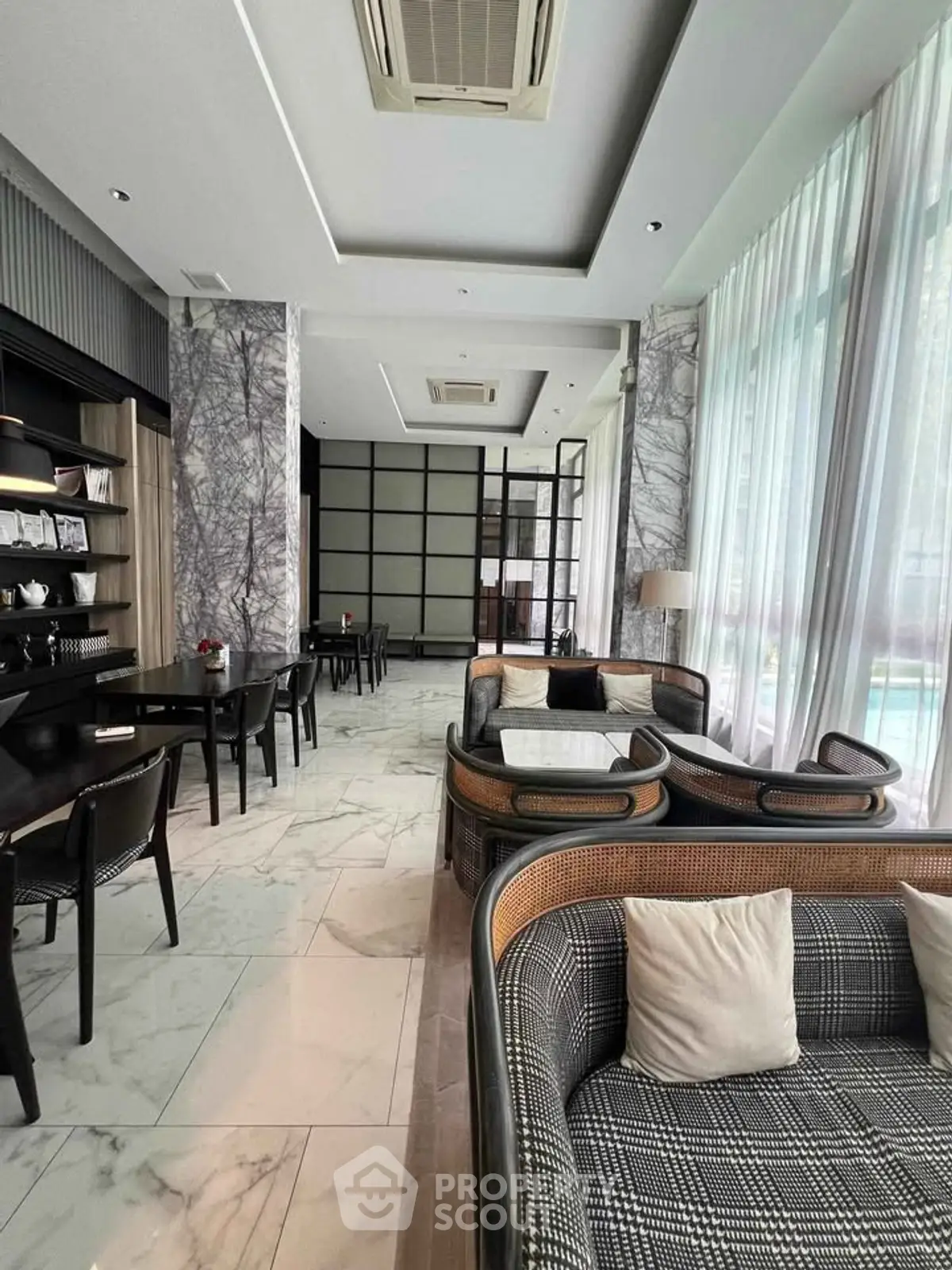 Luxurious modern lounge area with elegant seating and marble flooring, perfect for relaxation and social gatherings.