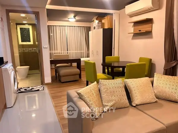 Modern living room with open layout, featuring stylish furniture and integrated dining area.