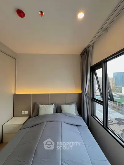 Modern bedroom with large windows and stylish lighting in urban apartment