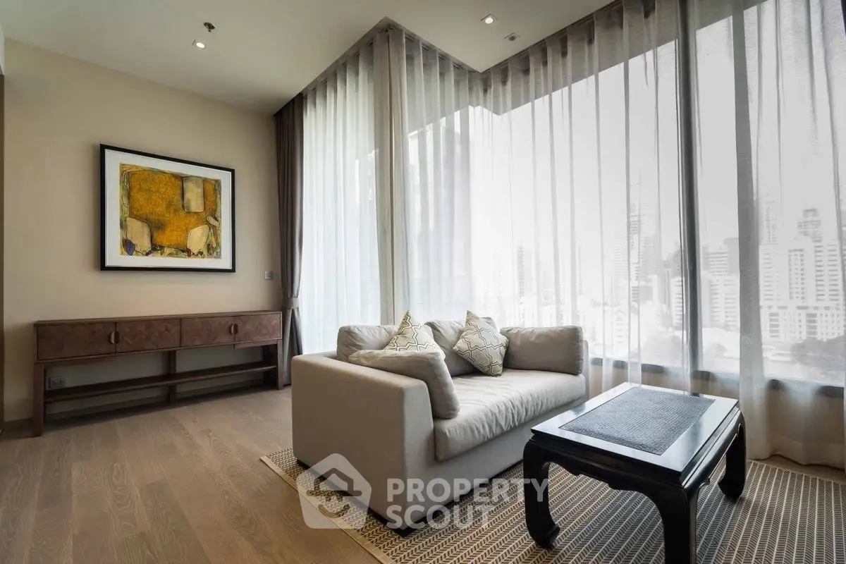 Luxurious living room with modern decor and city view, featuring elegant furniture and floor-to-ceiling windows.